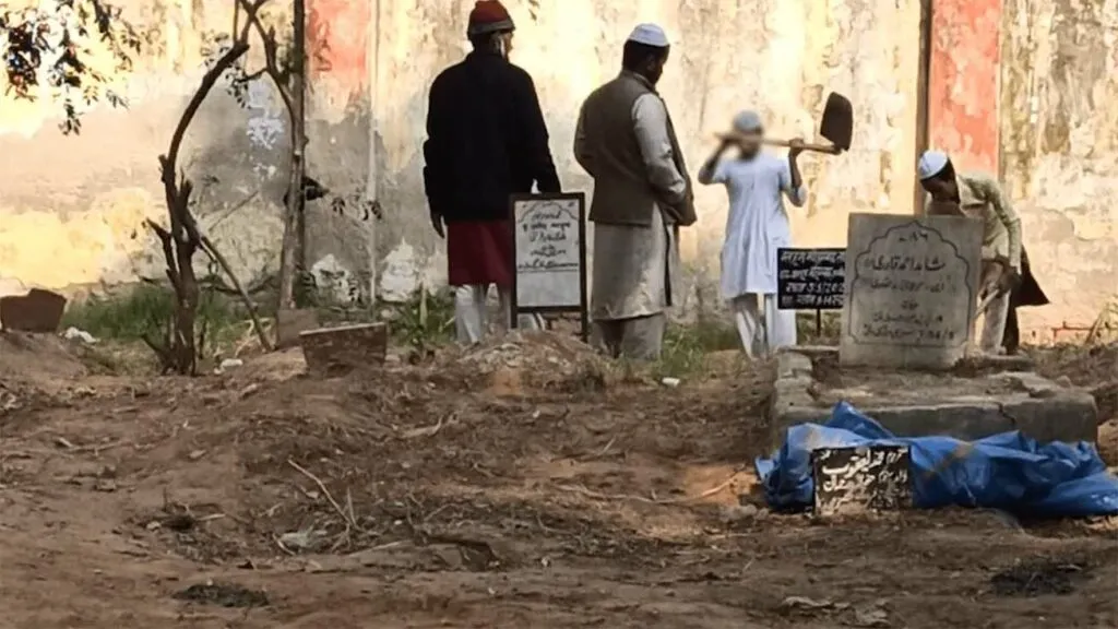 A child seen digging a grave under elderly supervision | The Probe